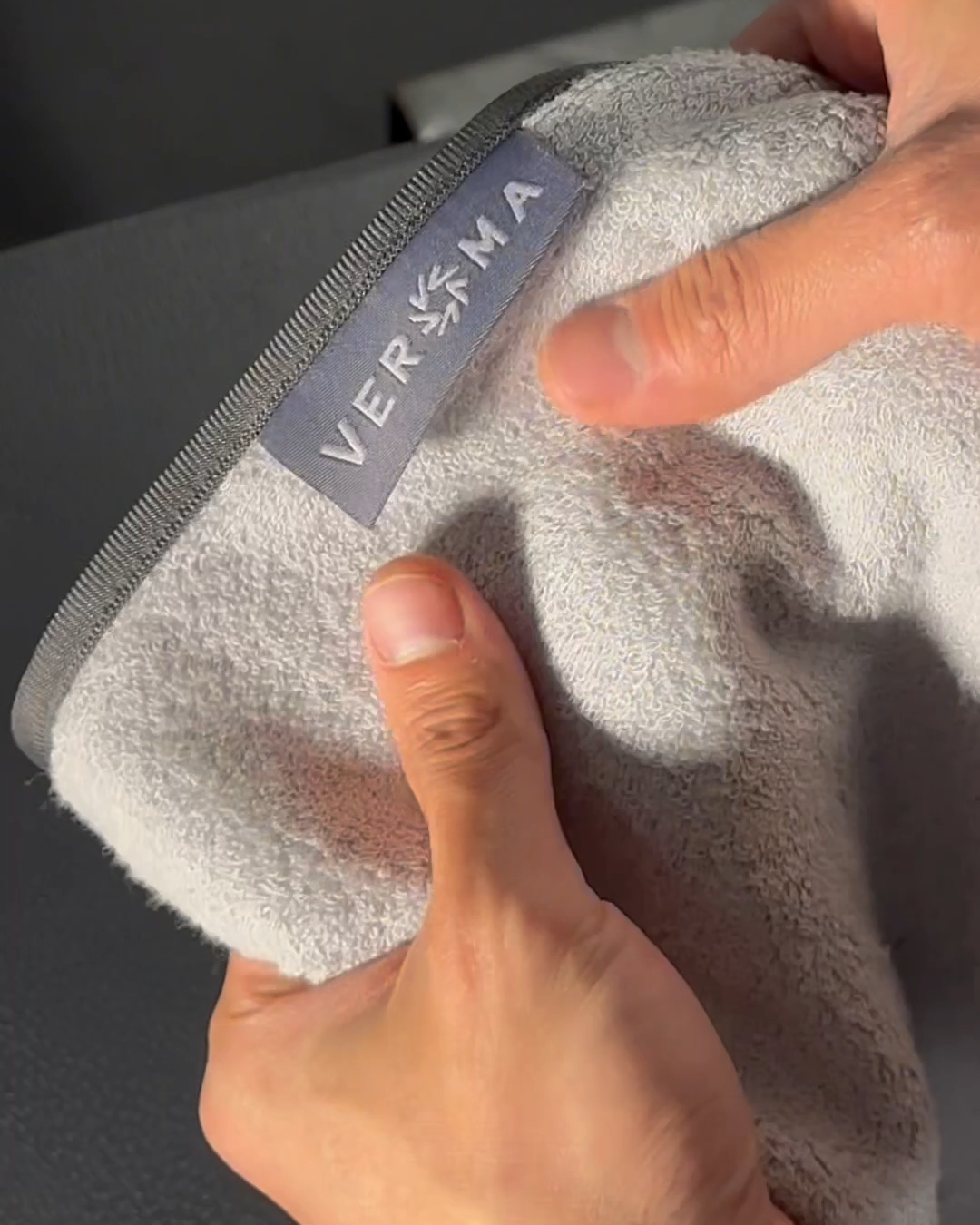 Veroma bamboo cotton gym towel spread out on a wooden surface, showcasing its soft texture and absorbent material.
